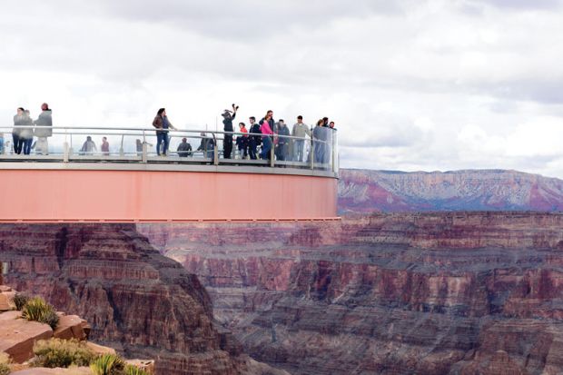 People standing on the The Skywalk on cantilever bridge in Arizona near the Colorado River