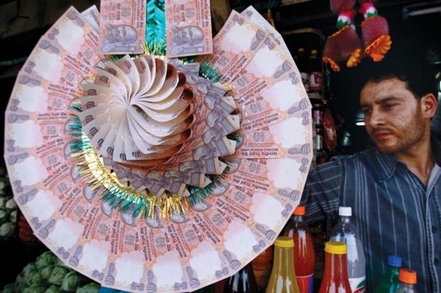 Display of a garland made of Indian currency notes to illustrate Increasing academic salaries must be a priority if India’s new independent research funder is to turbocharge science.