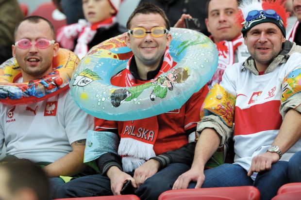 Polish fans wear aquatic equipment before the World Cup qualifying football match to illustrate Experts sceptical about Polish research assessment proposals