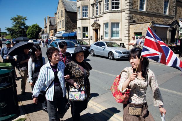 Chinese tourists take a guided tour at Bourton-on-the-Water UK to illustrate Chinese students ‘prefer UK to other study destinations’