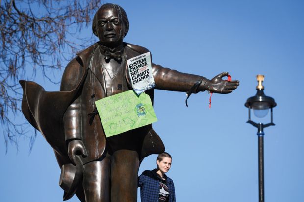 A student stands on the plinth of a statue of former Prime Minister David Lloyd George with climate change posters on the statue as a metaphor for picking fights with students ‘deflection strategy’ for ministers