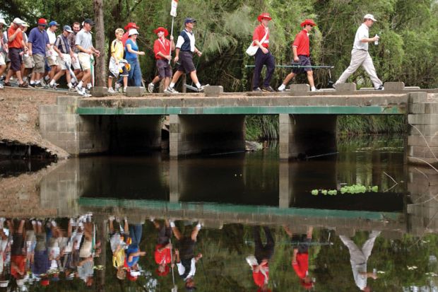 Large group walk over a bridge in the Gold Coast, Australia to illustrate, liberate teaching materials from paywalls, urges professor