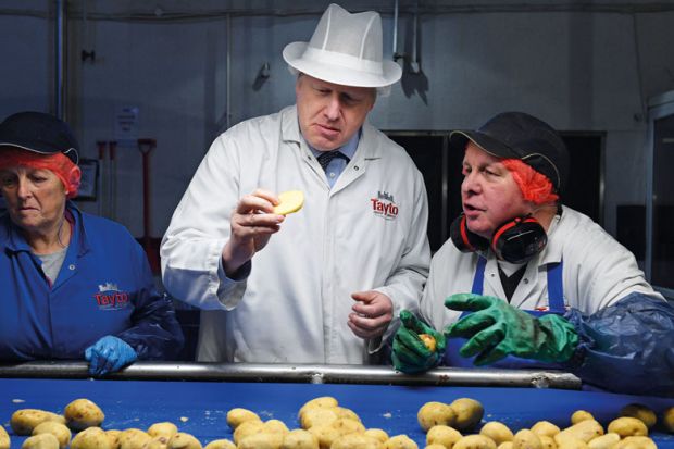 Boris Johnson checks a potato for quality with the control staff to illustrate English student number caps ‘set to use new outcomes measures’