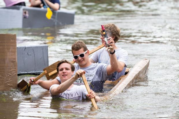 Cambridge University students  on the River Cam taking part in Suicide Sunday cardboard boat race to illustrate Will Labour commit to a graduate tax in England?