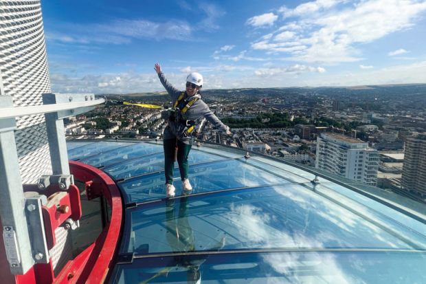  A visitor to British Airways i360 Viewing Tower in Brighton standing on the skywalk to illustrate TPS: universities seek respite from £125 million pensions bill