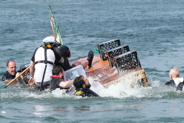 Image of A raft capsizes during a raft race with people falling into the water as a metaphor for Fears for UK research as EU postdoc applications dry up.