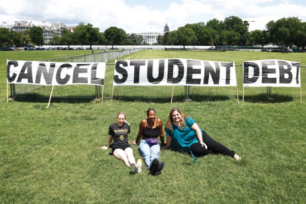 Students with banner reading 'Cancel student debt'  in front of The White House to explain that the Democrats frustrated as Biden stays cautious on higher education
