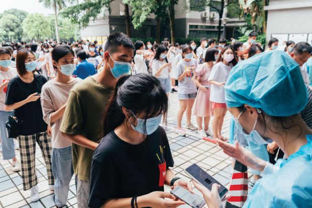 Students queue up for nucleic acid test at Guangdong University of Foreign Studies as they are mentioned in the copy. 