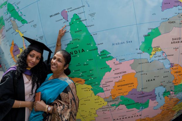 Graduate and lady pose for photograph infant of giant globe to illustrate Offer loans to turbocharge Indian recruitment, Johnson tells UK