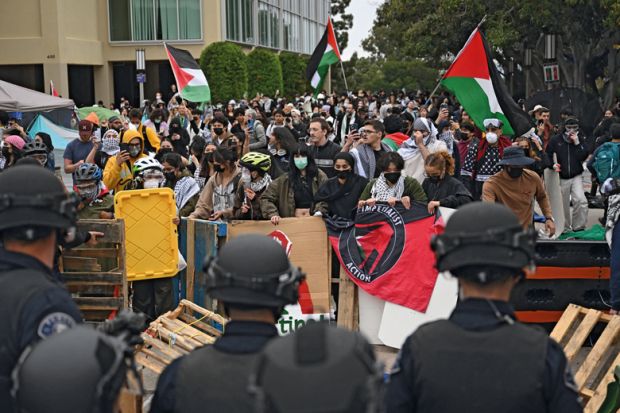 Pro-Palestinian demonstrators confront police as they clear an encampment after students occupied the Physical Sciences Lecture Hall at the University of California to illustrate Colleges ‘declare war’ on Gaza protest movement ahead of new year