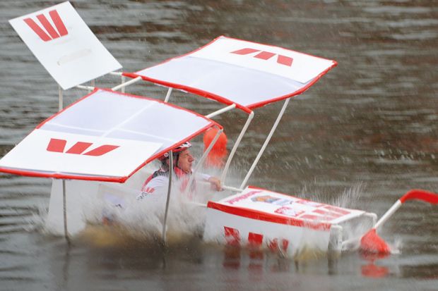 Pilot David Hyde crashes his plane into the Yarra River during the annual Birdman competition, in Melbourne to illustrate Record losses at Australian universities