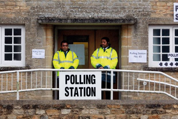 Security staff stand at the polling station to illustrate I’m a bouncer, but don’t ask me to evict students from polling booths
