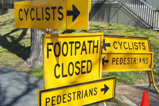 Multiple signs indicating closed foot and cycle paths in Australia to illustrate Australian universities spar over plans for new oversight body