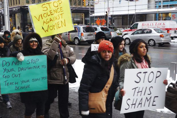 Woman, many of them of South-Asian origin, demonstrate in Toronto, Ontario to illustrate US and Canadian students protest over sexual assaults