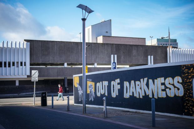  A hoarding surrounds a brownfield site waiting for redevelopment in the Horseley Fields area of Wolverhampton with graffiti reading 'Out of the darkness' to illustrate Post-92s ‘inspire and drive social mobility’