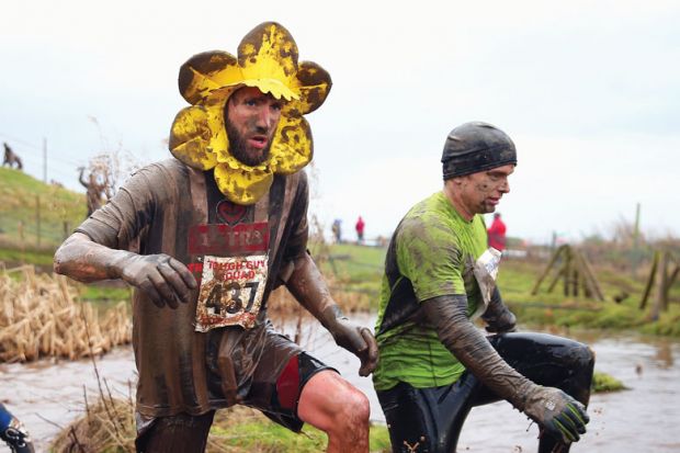  A competitor runs wearing a flower around his head covered in mud as a metaphor for UK ‘needs coherent plan’ for research spending after Horizon row. 