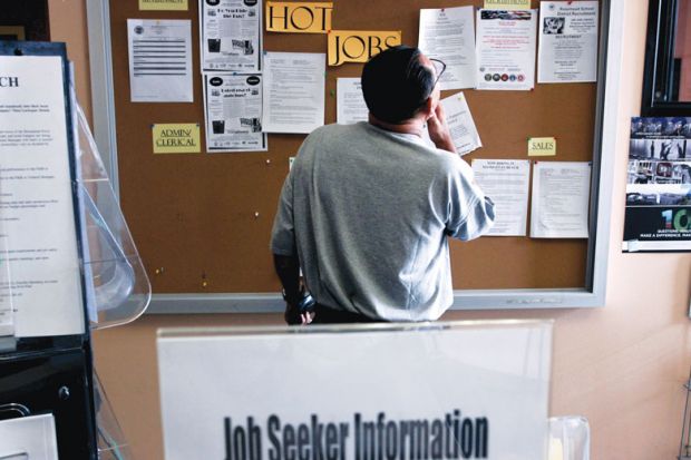 A job seeker looks at postings for jobs at the Verdugo Jobs Center, which includes a California Employment Development satellite office
