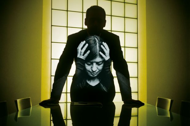 Shadow person standing at desk with image of lady holding her head  within the shadow body shape