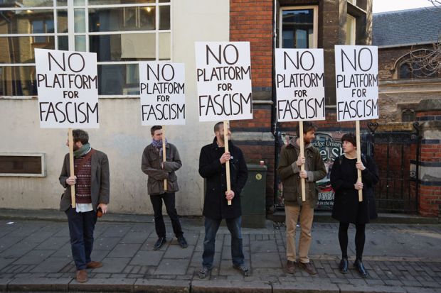 Protesters gather outside Cambridge University's Student Union holding banners reading 'No platform for fascism'