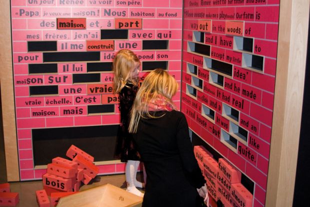 People at an Educational exhibit of Robert Munsch at the McCord Museum Montreal Canada looking at an exhibit of words missing to illustrate McGill warns French-language plan ‘puts its future in question’
