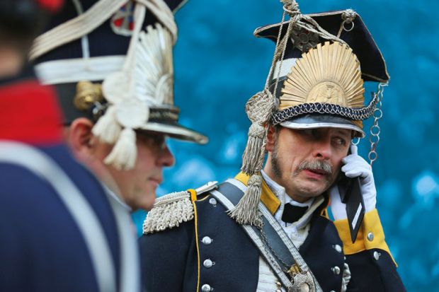  An actor in the role of a soldier in the 7th Polish Lancer Regiment talks on a mobile phone upon his arrival for the opening ceremony to commemorate the 200th anniversary of The Battle of Nations