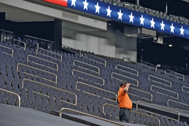  A security guard salutes while standing among empty seatsin Las Vegas, Nevada to illustrate US universities fear ‘ghosting’ by international students