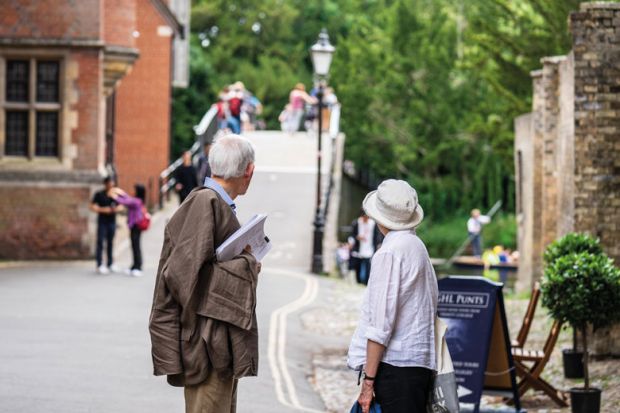 Elderly couple walking down the street in Cambridge to illustrate ‘Forced retirement’ rules face new challenge at Cambridge