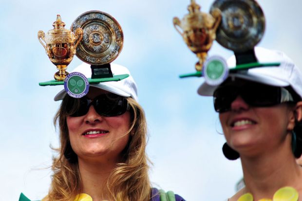 Tennis fans wear hats featuring the cups during the Wimbledon Tennis Championships to illustrate Royal Society offers publishing discounts for peer reviewers