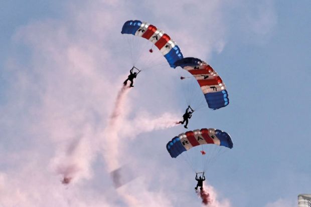 The Air Force parachute display team perform in the air coming down to illustrate French universities demand action as PhD enrolments slump