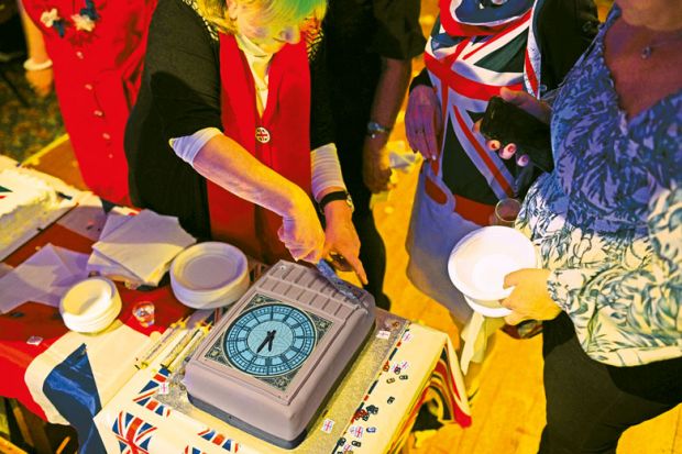 Cutting a cake in the form of Big Ben to illustrate London’s tight grip on  English higher education policy must be broken