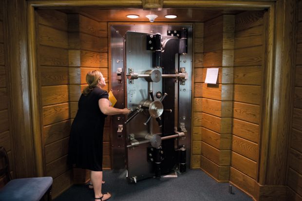 Person opens the library's vault located in the basement of the Folger Shakespeare Library, Washington to illustrate US universities protest against research fraud transparency rules