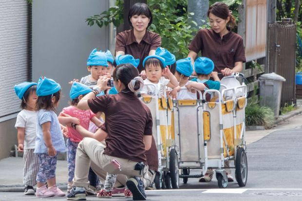 Japanese nursery babies in an outing at Kamimeguro street, Tokyo, Japan to illustrate Tokyo axes tuition fees for large families to boost universities