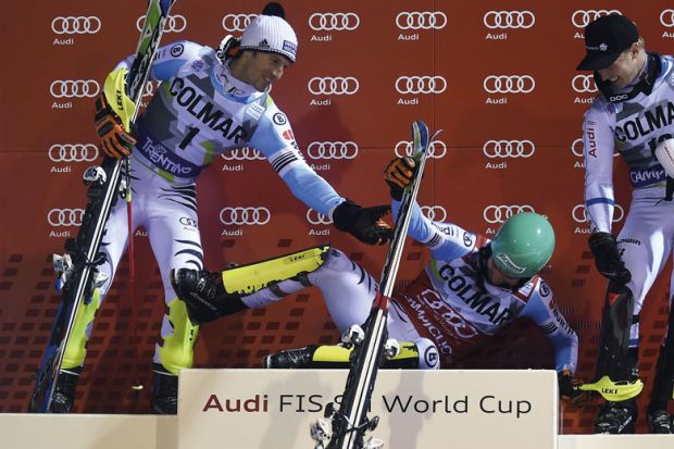 Second placed Germany's Fritz Dopfer (L) and third placed Sweden's Jens Byggmark (R) assists first placed Germany's Felix Neureuther (C) onto the podium after competing in the Men's Slalom event during the FIS Ski World Cup to illustrate Head of rectors’ 