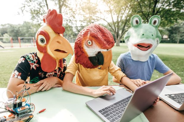 Three people wearing head costume masks looking at laptops as a metaphor for Cheating firms offer Zoom proxy