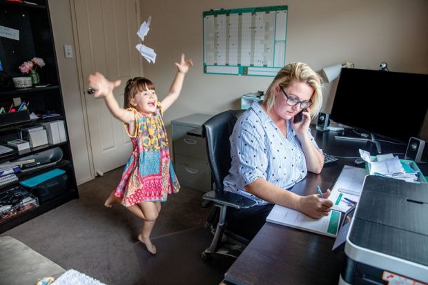 Mother attempts to work from home on the computer and phone whilst her daughter copies her, makes a mess and throws the laundry around. for University staff less happy and more anxious than UK average