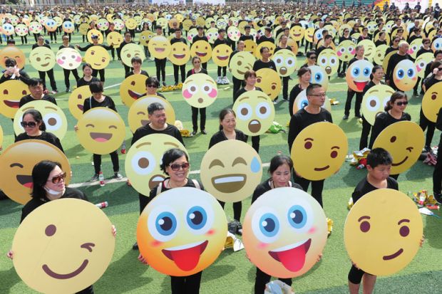 People holding emoji faces to illustrate boycott-busting Queen Mary markers blasted for ‘basic’ feedback