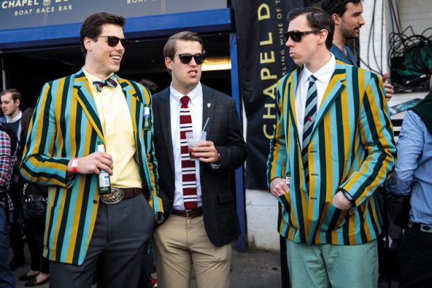 Spectators wearing boating blazers gather during the annual Boat Race between Oxford and Cambridge University to illustrate rooting out elites’ influence