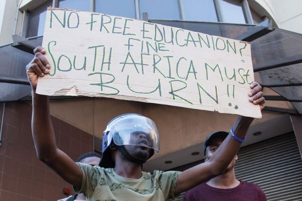 :Students stage a protest over government's plan of increasing university tuition feesi in front of the Parliament building in Cape Town, South Africa