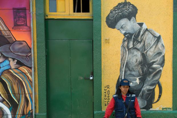 Woman standing in front of door, Santiago, Santiago Metropolitan Region, Chile
