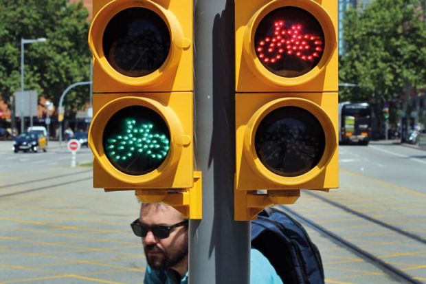 Pedestrian bicycle traffic light in Barcelona both red and green lights are on to illustrate Spanish universities law extends ‘long tradition’ of mistrust