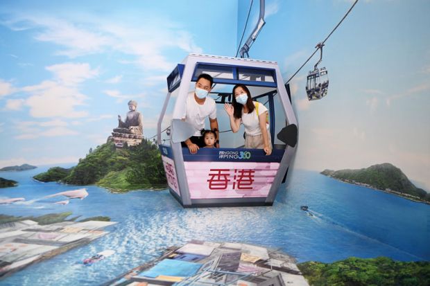 : Visitors pose for photos with a 3D art installation during an exhibition to illustrate China’s promised research reform ‘little more than PR exercise’