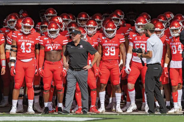 Houston head coach Dana Holgorsen prepares to lead the team onto the field to illustrate Let’s beef up post-tenure review – especially for football coaches