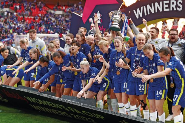 Chelsea celebrate on the podium as the boarding falls down during the Vitality Women's FA Cup Final match to illustrate Complacent universities stuck on?bottom rung of Athena Swan