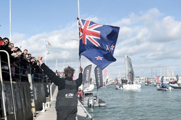 Man, holding a New Zealand national flag, greeting supporters to illustrate Branch campuses ‘not the way forward’ for New Zealand