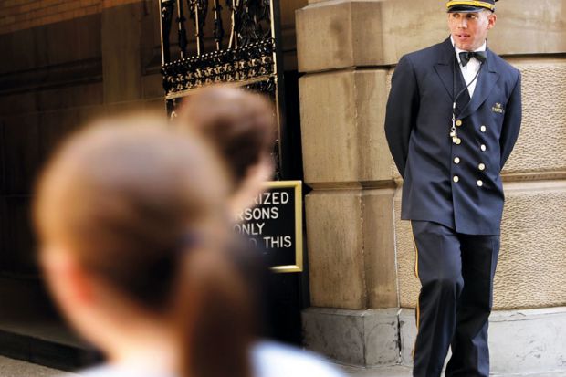 A doorman works in front of a landmark building to illustrate More US states to automatically enrol high schools’ top graduates in college