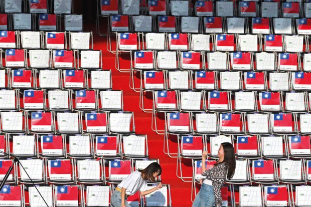 Two people in front of empty seating in Taiwan to illustrate Scholars doubtful of Taiwan’s international student target