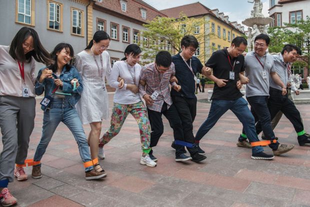 Huawei workers play a 'team building' game at the end of the lunch break at the new sprawling 'Ox Horn' Research and Development campus 