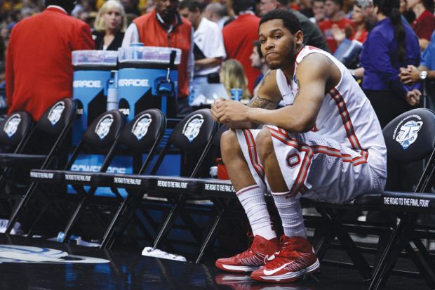 Amir Williams f the Ohio State Buckeyes sits on the bench by himself after losing  NCAA Men's Basketball Tournament 