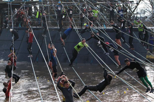 Participants climb ropes over water to illustrate English economic model ‘unravelling’ as more students miss out