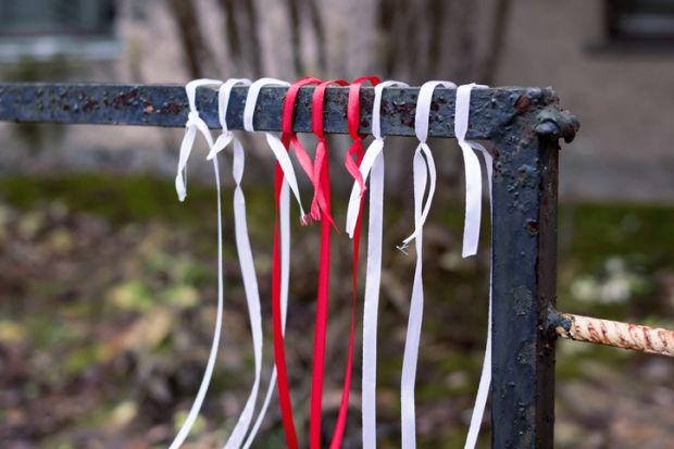 White-red-white ribbons on the fence, protests in Belarus